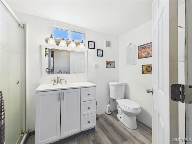 1847 Tuscarora Rd, Niagara, NY 14304 - full bathroom featuring wood finished floors, toilet, a shower stall, and vanity