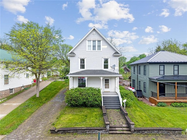 8 Washington St, Alexandria, NY 13607 - view of front of house featuring a front yard, cooling unit, covered porch, and driveway