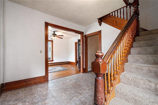 8 Washington St, Alexandria, NY 13607 - stairway featuring baseboard heating, baseboards, ceiling fan, and tile patterned floors