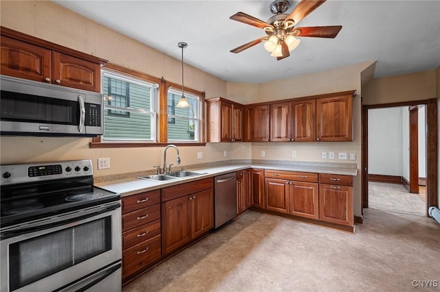 8 Washington St, Alexandria, NY 13607 - kitchen with stainless steel appliances, a sink, light countertops, brown cabinetry, and pendant lighting