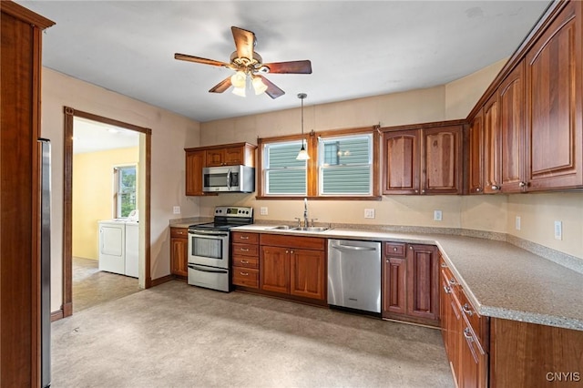 8 Washington St, Alexandria, NY 13607 - kitchen with appliances with stainless steel finishes, a sink, washing machine and clothes dryer, ceiling fan, and brown cabinets