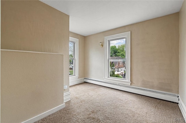 8 Washington St, Alexandria, NY 13607 - carpeted spare room featuring a baseboard heating unit, healthy amount of natural light, and baseboards