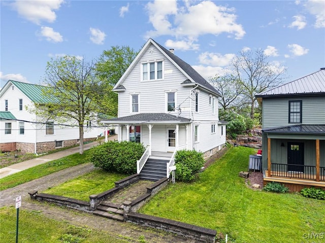 8 Washington St, Alexandria, NY 13607 - view of front of house featuring covered porch and a front yard
