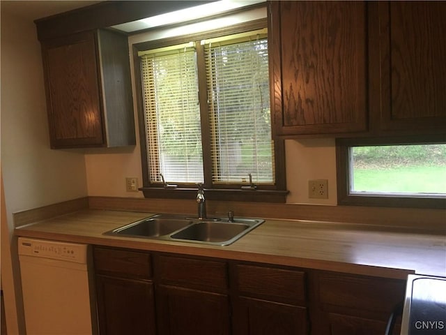7653 Windsor Dr N, Clay, NY 13212 - kitchen with white dishwasher, a sink, healthy amount of natural light, and wooden counters