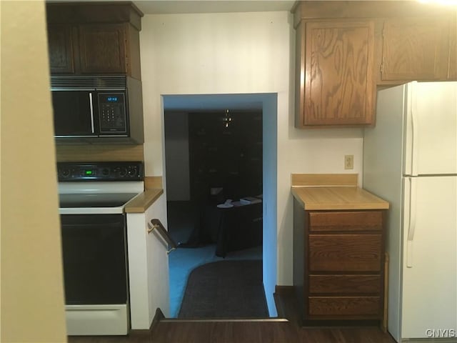 7653 Windsor Dr N, Clay, NY 13212 - kitchen with electric range oven, freestanding refrigerator, black microwave, and dark wood-style floors