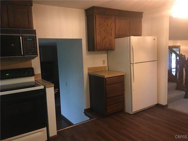 7653 Windsor Dr N, Clay, NY 13212 - kitchen featuring range with electric cooktop, black microwave, freestanding refrigerator, and dark wood-style floors