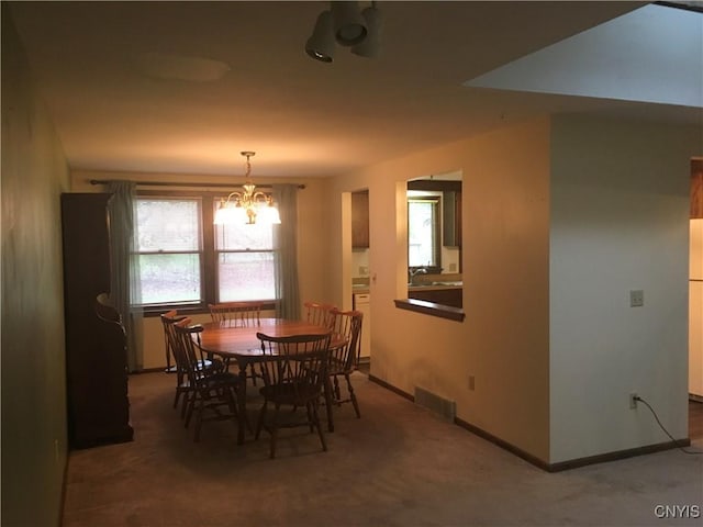 7653 Windsor Dr N, Clay, NY 13212 - dining room featuring carpet flooring, a chandelier, and baseboards