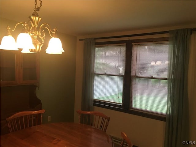 7653 Windsor Dr N, Clay, NY 13212 - dining room featuring a chandelier and wood finished floors