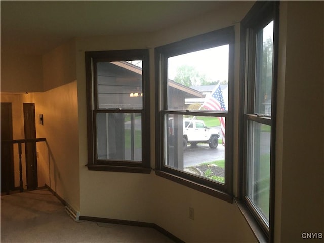 7653 Windsor Dr N, Clay, NY 13212 - spare room with healthy amount of natural light, carpet, and baseboards