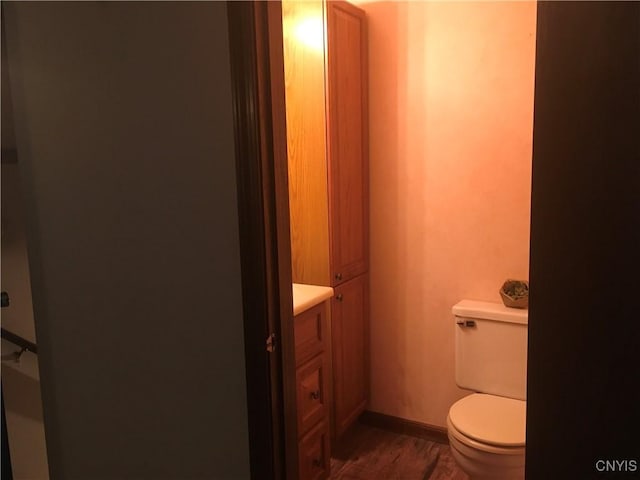 7653 Windsor Dr N, Clay, NY 13212 - bathroom featuring wood finished floors, toilet, vanity, and baseboards