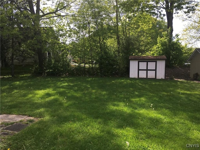 7653 Windsor Dr N, Clay, NY 13212 - view of grassy yard with a storage unit and an outbuilding
