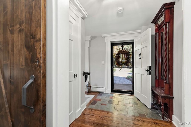 3721 Cold Springs Rd, Lysander, NY 13027 - foyer with a baseboard radiator, stone tile flooring, and baseboards