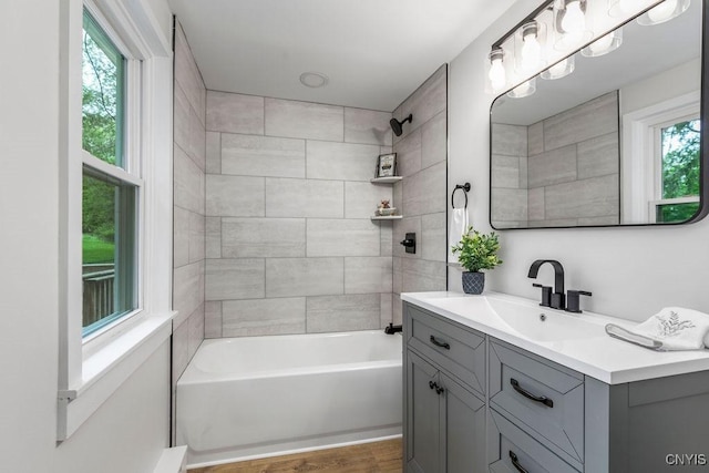 3721 Cold Springs Rd, Lysander, NY 13027 - full bathroom featuring plenty of natural light, vanity, shower / washtub combination, and wood finished floors