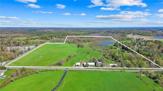 aerial view of property and surrounding area featuring a forest and property parcel outlined