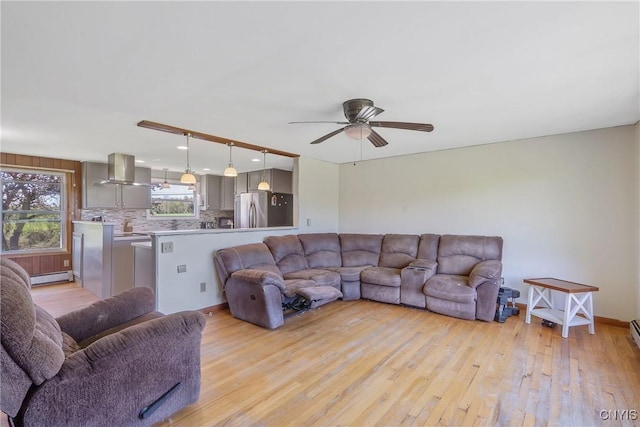 living area with light wood-style flooring, a baseboard radiator, a ceiling fan, recessed lighting, and baseboards