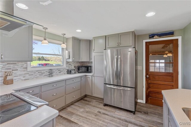 2226 County Route 37, West Monroe, NY 13036 - kitchen featuring freestanding refrigerator, black microwave, gray cabinetry, light wood-style floors, and tasteful backsplash