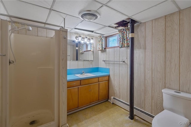 full bathroom with a stall shower, toilet, a baseboard radiator, and vanity