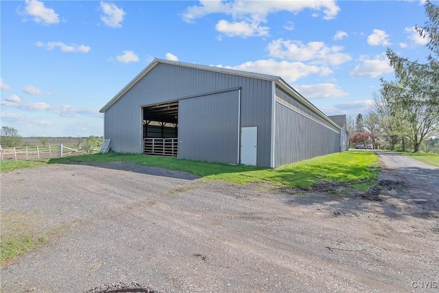 view of pole building with fence