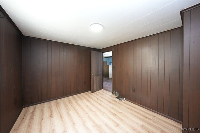 8 Wagner Ave, Cheektowaga, NY 14206 - empty room featuring light wood-style floors and wood walls