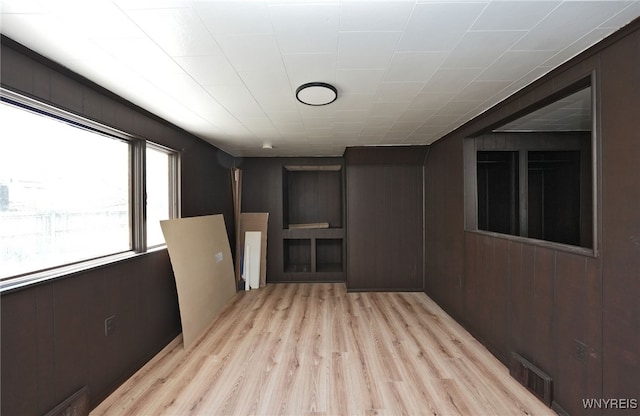 8 Wagner Ave, Cheektowaga, NY 14206 - empty room with light wood-type flooring and wooden walls