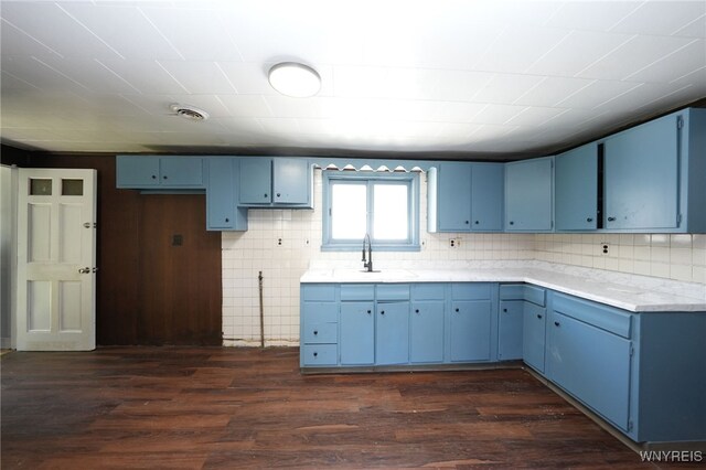 8 Wagner Ave, Cheektowaga, NY 14206 - kitchen featuring blue cabinetry, dark wood-type flooring, and a sink