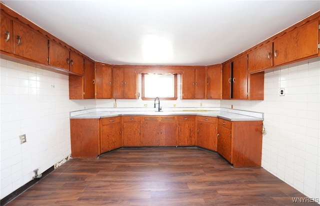 8 Wagner Ave, Cheektowaga, NY 14206 - kitchen featuring brown cabinets, tile walls, light countertops, dark wood finished floors, and a sink