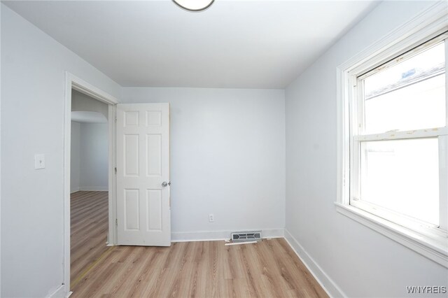 8 Wagner Ave, Cheektowaga, NY 14206 - empty room featuring light wood finished floors, baseboards, and arched walkways
