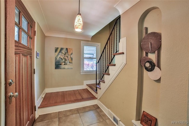 696 Cleveland Dr, Cheektowaga, NY 14225 - foyer entrance with tile patterned floors, stairway, and baseboards