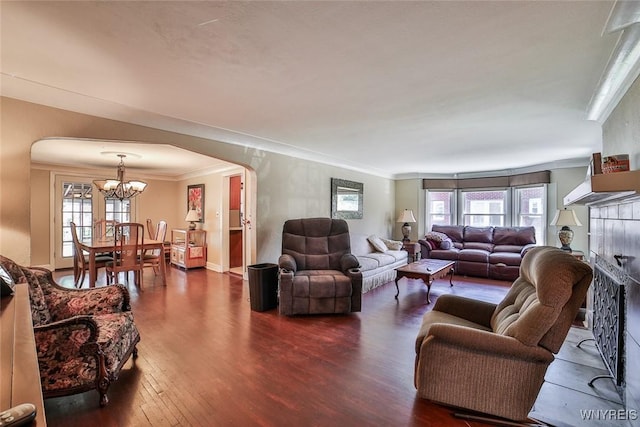 696 Cleveland Dr, Cheektowaga, NY 14225 - living area with arched walkways, a chandelier, wood finished floors, ornamental molding, and healthy amount of natural light