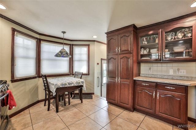 696 Cleveland Dr, Cheektowaga, NY 14225 - kitchen featuring light countertops, crown molding, glass insert cabinets, baseboards, and tasteful backsplash