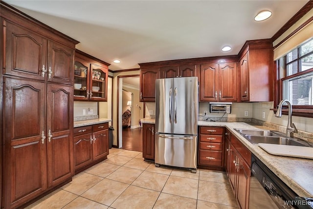 696 Cleveland Dr, Cheektowaga, NY 14225 - kitchen featuring stainless steel appliances, a sink, crown molding, light countertops, and light tile patterned floors