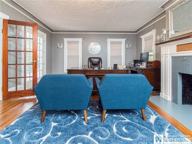 474 Fairmount Ave, Ellicott, NY 14701 - home office featuring wood finished floors, a fireplace, a textured ceiling, ornamental molding, and french doors