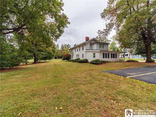 474 Fairmount Ave, Ellicott, NY 14701 - view of property exterior with a chimney and a lawn