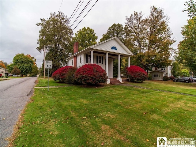 474 Fairmount Ave, Ellicott, NY 14701 - greek revival house featuring a chimney, a front lawn, and a porch