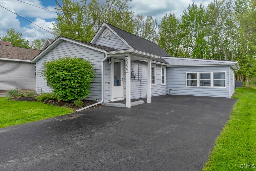 6054 Muskrat Bay Rd, Cicero, NY 13029 - view of front of home featuring a front yard, asphalt driveway, and roof with shingles