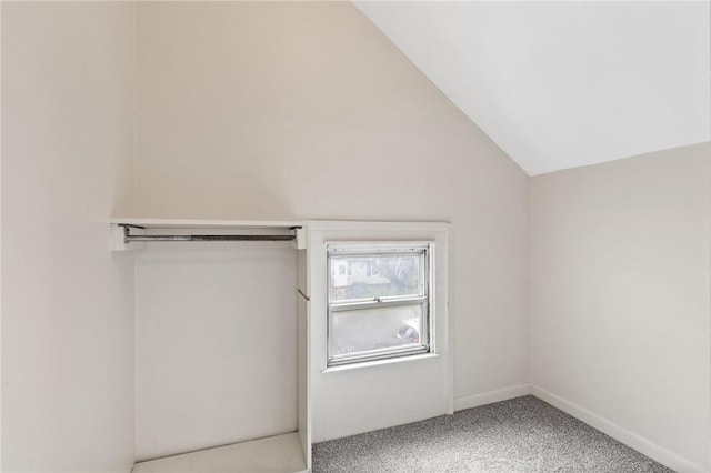 bonus room with light carpet and lofted ceiling
