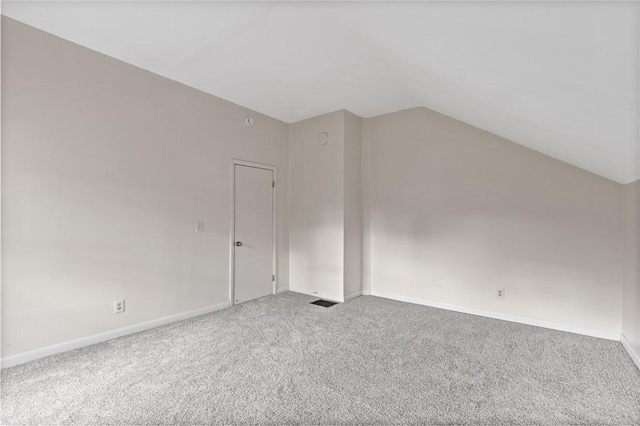 additional living space with carpet, vaulted ceiling, and baseboards