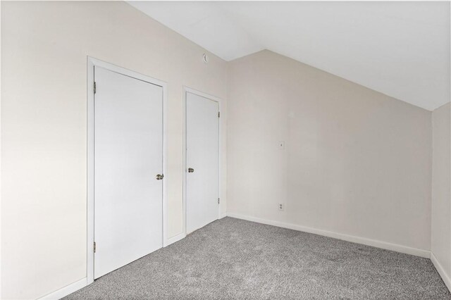 bonus room with carpet floors, lofted ceiling, and baseboards