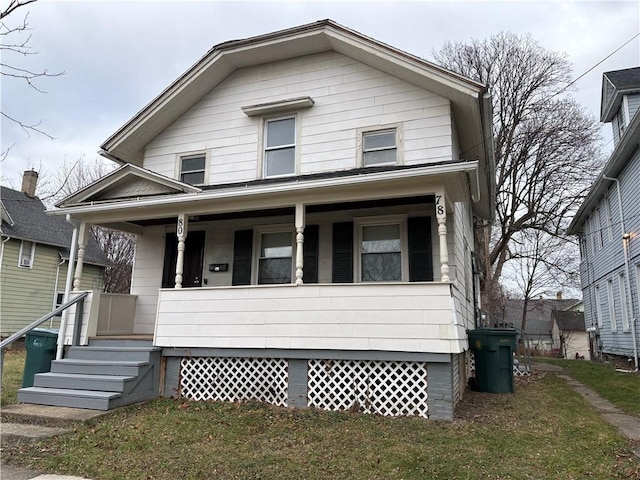 view of front of house with a porch and a front yard