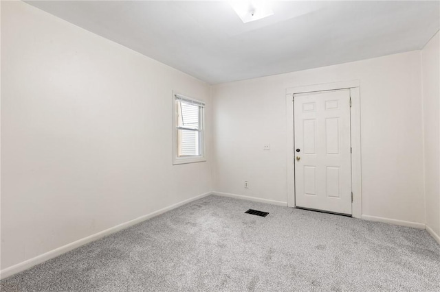 carpeted spare room with baseboards