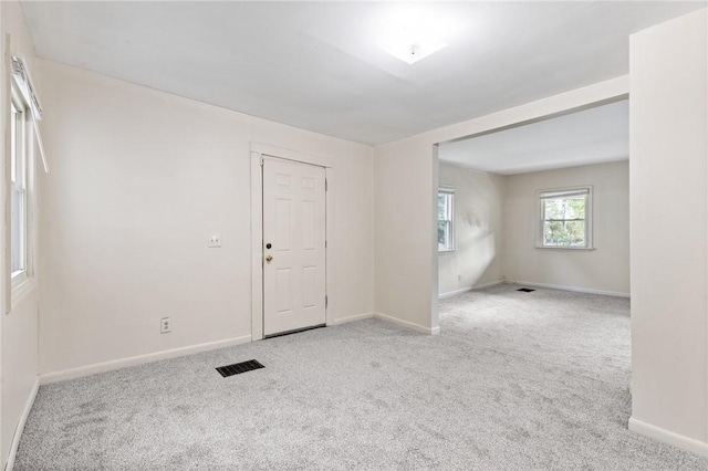 empty room with baseboards and carpet