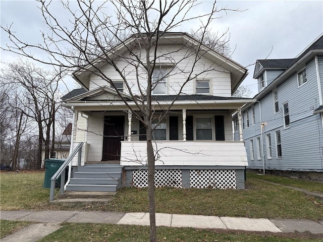 view of front of home with a porch and a front yard