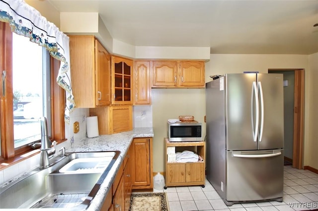 150 Leonard St, Lackawanna, NY 14218 - kitchen featuring stainless steel appliances, a sink, glass insert cabinets, backsplash, and light tile patterned floors