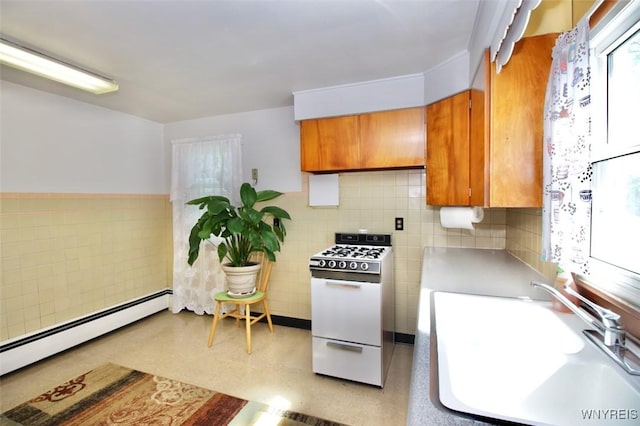 150 Leonard St, Lackawanna, NY 14218 - kitchen with white gas stove, a sink, brown cabinets, tile walls, and baseboard heating