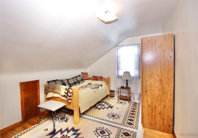 150 Leonard St, Lackawanna, NY 14218 - bedroom with vaulted ceiling, wood finished floors, and baseboard heating