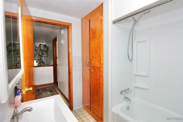150 Leonard St, Lackawanna, NY 14218 - bathroom with tub / shower combination, a textured ceiling, and tile patterned floors