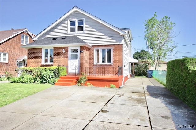 150 Leonard St, Lackawanna, NY 14218 - bungalow-style home with brick siding, a front lawn, and concrete driveway