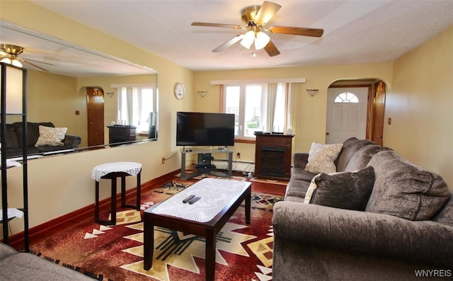 150 Leonard St, Lackawanna, NY 14218 - living area featuring arched walkways, ceiling fan, a baseboard heating unit, and baseboards
