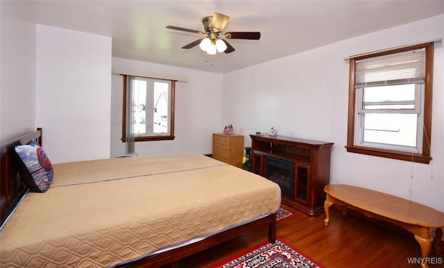 150 Leonard St, Lackawanna, NY 14218 - bedroom with multiple windows, wood finished floors, a fireplace, and a ceiling fan