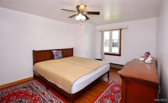 150 Leonard St, Lackawanna, NY 14218 - bedroom with wood finished floors, a baseboard radiator, baseboards, and a ceiling fan